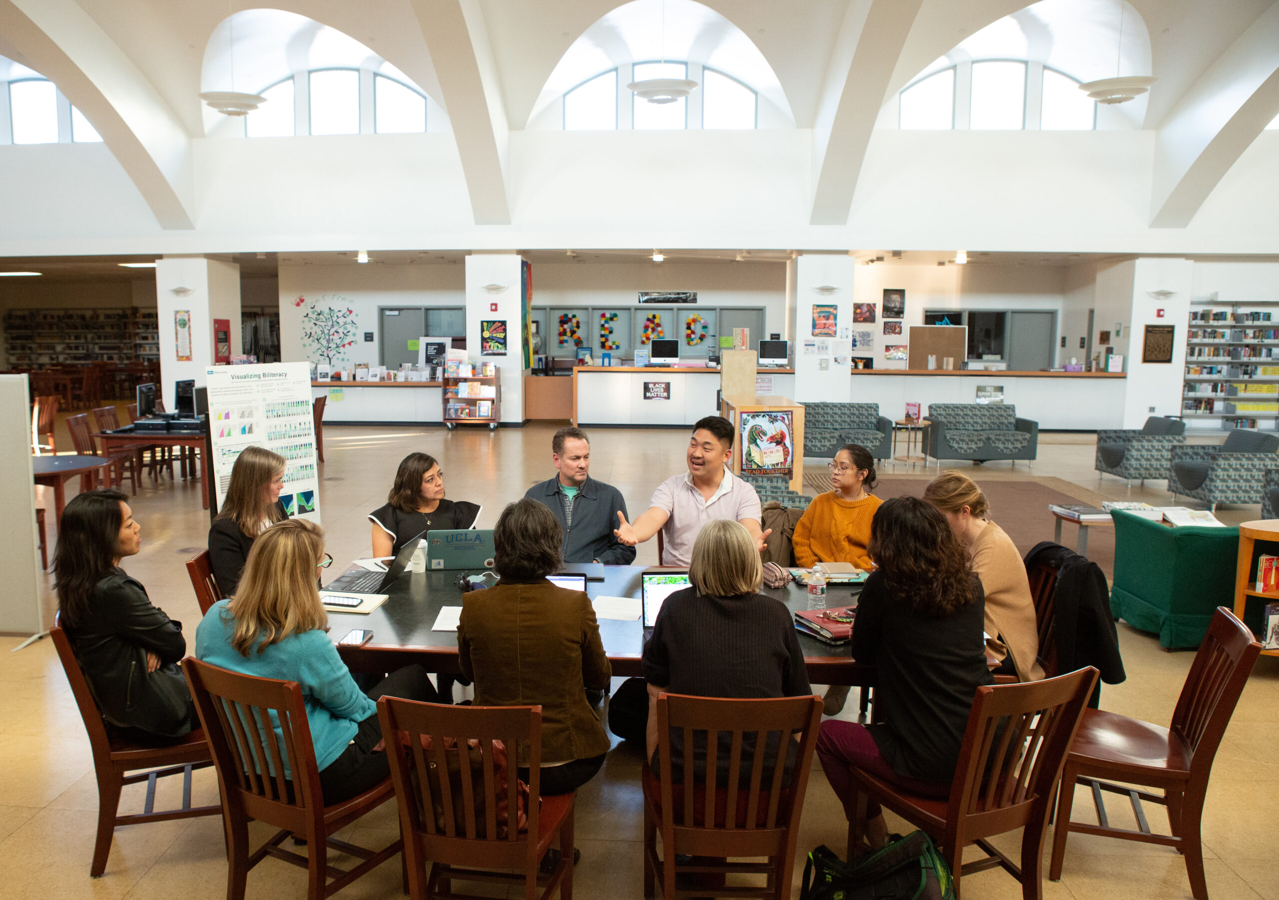 An image of teachers and staff meeting to discuss various research projects