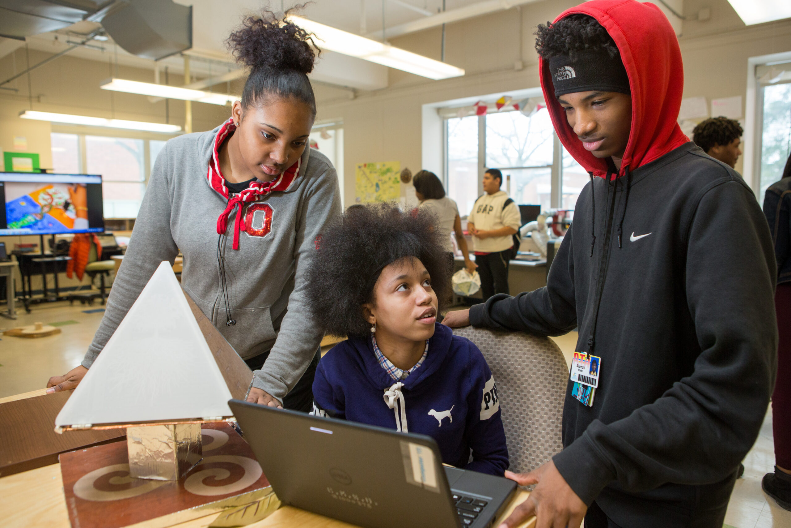 An image of tenth graders collaborating on an engineering project.